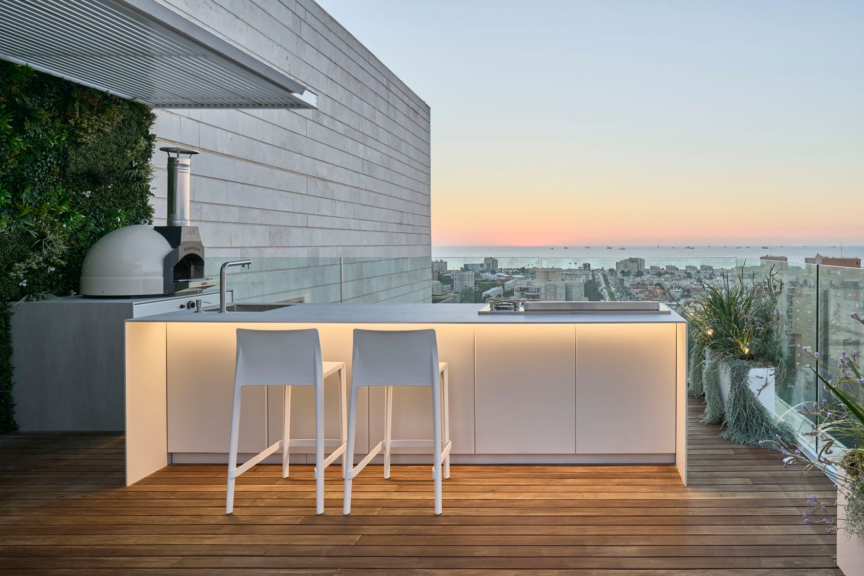 UNICA 300 rooftop kitchen at sunset with bar stools