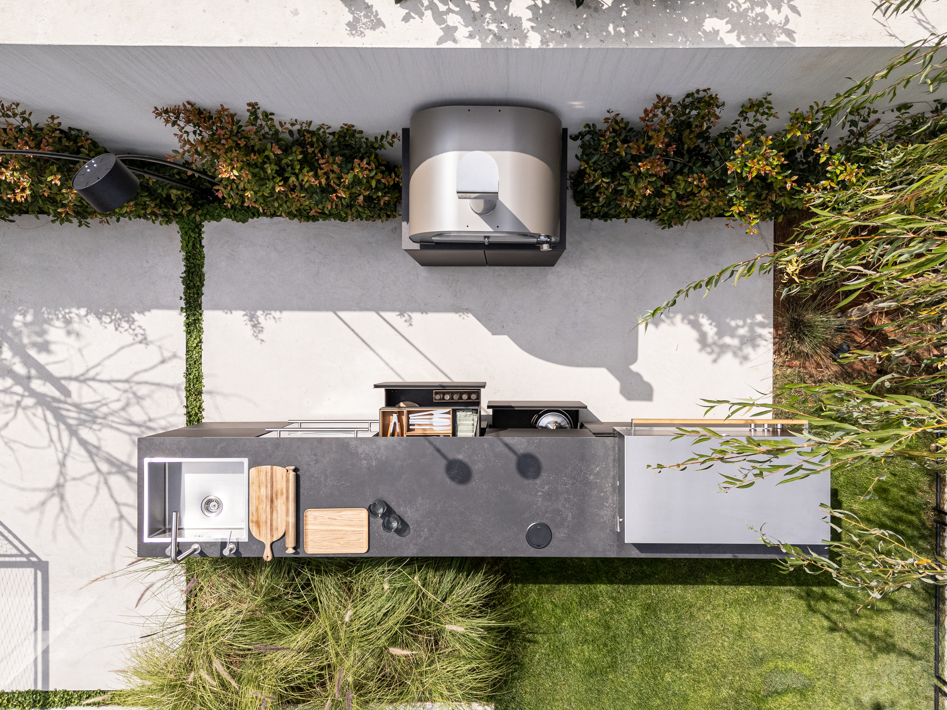Aerial view of UNICA island with smoker on a white patio